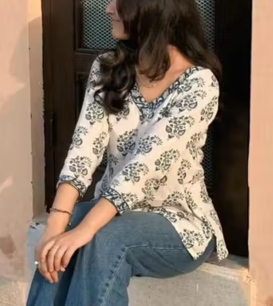 Pure Cotton Flower Printed V-Neck Designer Short Kurti For Women And Girls Best Comfy White Short Kurta With Blue Flower Print All Over The Kurti And Blue Flower Printed Lace Border Attached on Neckline And Sleeve